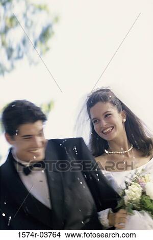 Confetti falling on a newlywed couple View Large Photo Image Picture - Confetti falling on a newlywed couple. Fotosearch