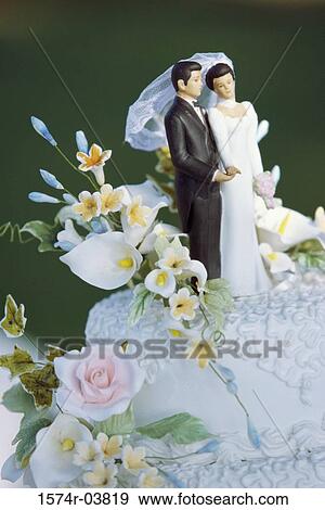 Stock Photo - Figures of a bride and groom on a wedding cake. Fotosearch