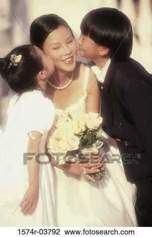 Flower girl and ring bearer kissing a bride View Large Photo Image Stock Image - Flower girl and ring bearer kissing a bride. Fotosearch