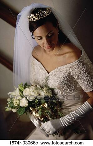 High angle view of a bride holding a bouquet of flowers View Large Photo Image Stock Image - High angle view of a bride holding a bouquet of flowers. Fotosearch
