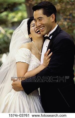 Newlywed couple embracing each other View Large Photo Image Stock Image - Newlywed couple embracing each other. Fotosearch
