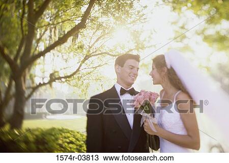 Stock Image - Newlywed couple looking at each other. Fotosearch