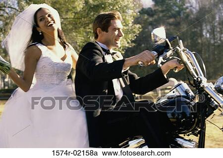 Newlywed couple riding on a motorcycle View Large Photo Image Stock Image - Newlywed couple riding on a motorcycle. Fotosearch