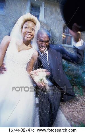 Stock Image - Newlywed couple running together. Fotosearch
