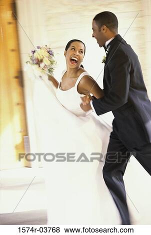 Stock Photo - Newlywed couple running together. Fotosearch