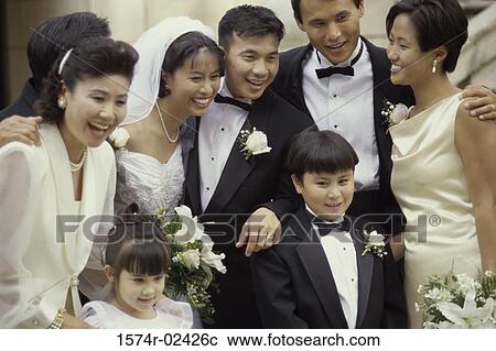 Newlywed couple smiling with their friends View Large Photo Image Stock Image - Newlywed couple smiling with their friends. Fotosearch