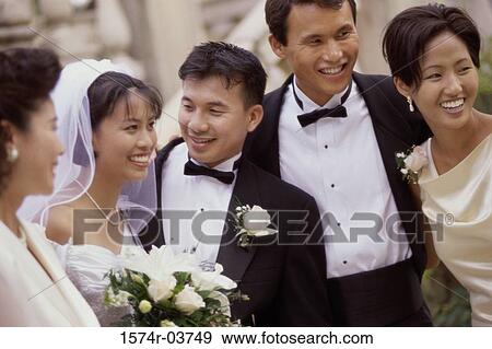 Newlywed couple smiling with their friends View Large Photo Image Stock Photo - Newlywed couple smiling with their friends. Fotosearch
