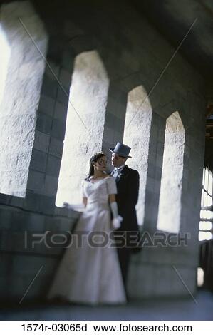 Newlywed couple standing in a castle View Large Photo Image Stock Image - Newlywed couple standing in a castle. Fotosearch