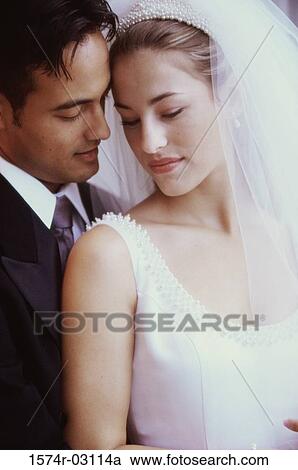 Stock Image - Newlywed couple standing together. Fotosearch