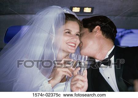 Newlywed couple toasting with champagne glasses in a car View Large Photo Image Stock Image - Newlywed couple toasting with champagne glasses in a car. Fotosearch