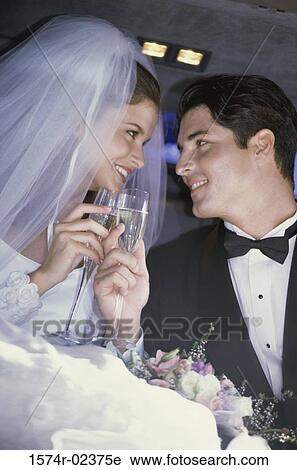 Newlywed couple toasting with champagne glasses in a car View Large Photo Image Stock Image - Newlywed couple toasting with champagne glasses in a car. Fotosearch