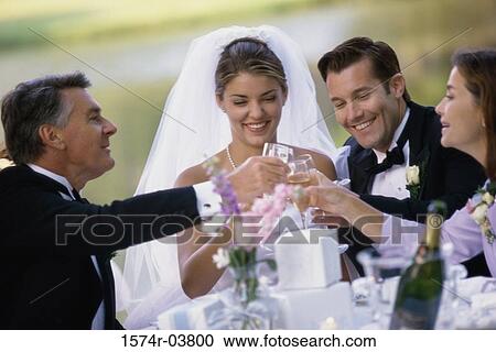 Newlywed couple toasting with their parents View Large Photo Image Stock Image - Newlywed couple toasting with their parents. Fotosearch