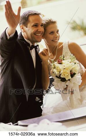 Newlywed couple waving from a convertible car View Large Photo Image Stock Image - Newlywed couple waving from a convertible car. Fotosearch