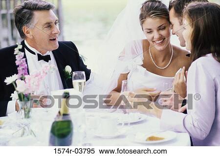 Stock Photography - Newlywed couple with their parents. Fotosearch