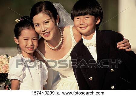 Stock Image - Portrait of a bride with a flower girl and a ring bearer. Fotosearch