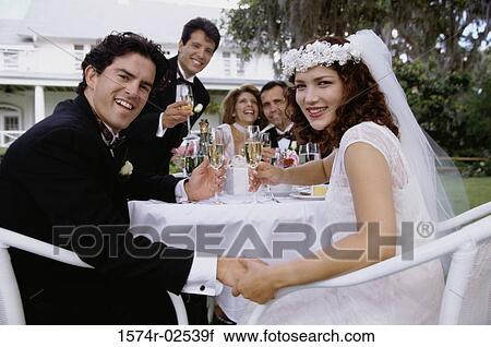 Portrait of a newlywed couple and their friends toasting with champagne glasses View Large Photo Image Stock Image - Portrait of a newlywed couple and their friends toasting with champagne glasses. Fotosearch