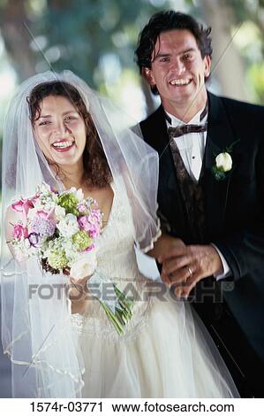Portrait of a newlywed couple smiling View Large Photo Image Stock Image - Portrait of a newlywed couple smiling. Fotosearch