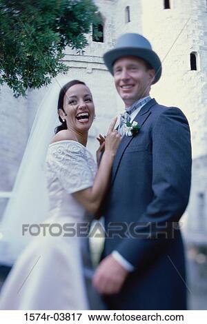 Portrait of a newlywed couple smiling View Large Photo Image Stock Photo - Portrait of a newlywed couple smiling. Fotosearch