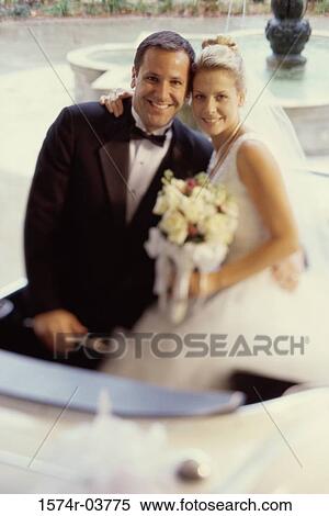 Portrait of a newlywed couple smiling View Large Photo Image Stock Photography - Portrait of a newlywed couple smiling. Fotosearch