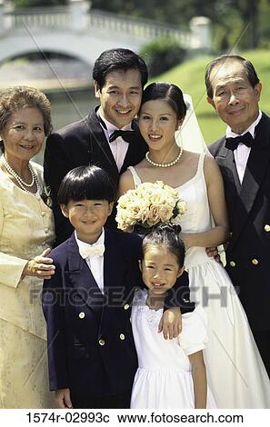 Portrait of a newlywed couple with their parents View Large Photo Image Stock Image - Portrait of a newlywed couple with their parents. Fotosearch