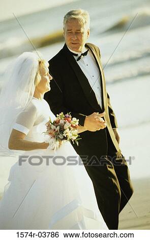 Senior couple walking on the beach View Large Photo Image Stock Photograph - Senior couple walking on the beach. Fotosearch