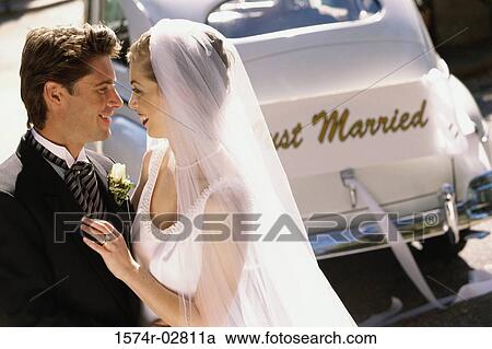Side profile of a newlywed couple smiling View Large Photo Image Stock Image - Side profile of a newlywed couple smiling. Fotosearch