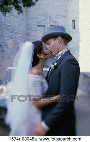 Side profile of a newlywed couple kissing each other View Large Photo Image Stock Image - Side profile of a newlywed couple kissing each other. Fotosearch