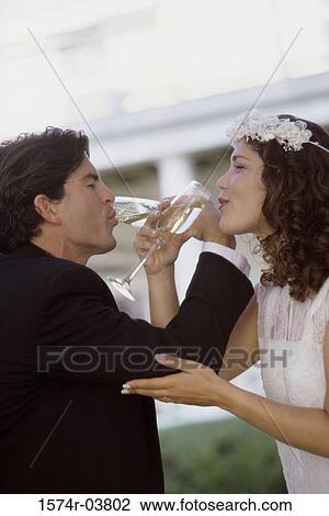 Side profile of a newlywed couple drinking champagne View Large Photo Image Stock Image - Side profile of a newlywed couple drinking champagne. Fotosearch