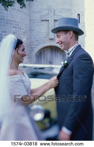 Stock Photo - Side profile of a newlywed couple smiling. Fotosearch