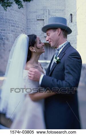Side profile of a newlywed couple embracing each other View Large Photo Image Stock Photography - Side profile of a newlywed couple embracing each other. Fotosearch