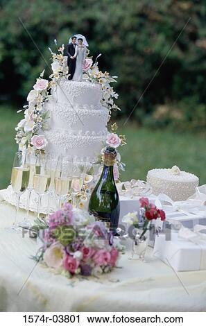 Wedding cake with a bouquet of flowers and a bottle of champagne View Large Photo Image Stock Image - Wedding cake with a bouquet of flowers and a bottle of champagne. Fotosearch