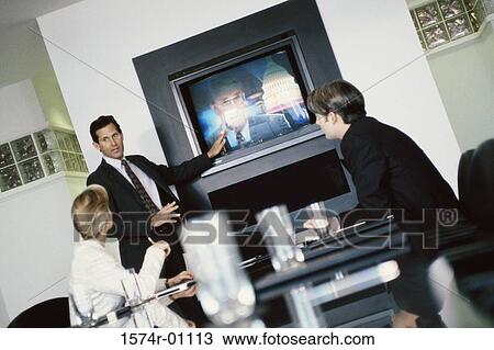 Business executives watching a presentation in a conference room View Large Photo Image Stock Image - Business executives watching a presentation in a conference room. Fotosearch