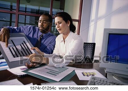 Businessman and businesswoman giving a presentation View Large Photo Image Stock Image - Businessman and businesswoman giving a presentation. Fotosearch