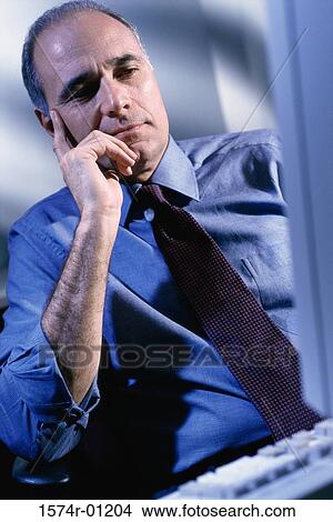 Picture - Businessman looking at a computer screen. Fotosearch