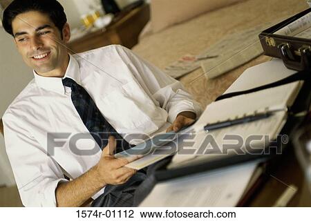 Stock Image - Businessman sitting at a desk. Fotosearch