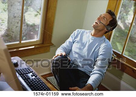 Businessman talking on a headset View Large Photo Image Stock Photo - Businessman talking on a headset. Fotosearch