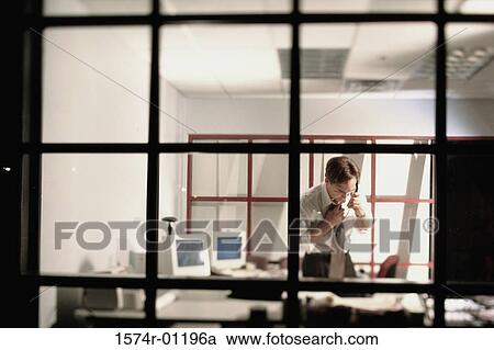 Businessman talking on a landline telephone on the desk View Large Photo Image Stock Image - Businessman talking on a landline telephone on the desk. Fotosearch