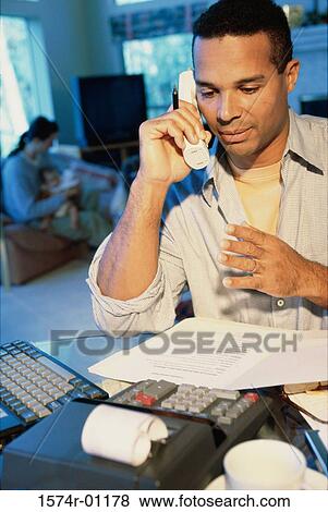 Stock Photo - Businessman talking on a landline telephone. Fotosearch