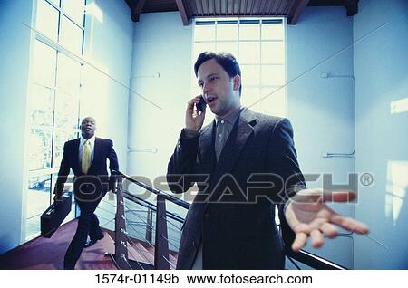 Businessman talking on a mobile phone View Large Photo Image Stock Image - Businessman talking on a mobile phone. Fotosearch