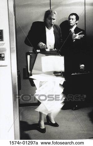 Businesswoman standing in an elevator View Large Photo Image Stock Image - Businesswoman standing in an elevator. Fotosearch