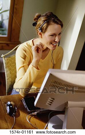 Stock Image - Businesswoman talking on a headset. Fotosearch