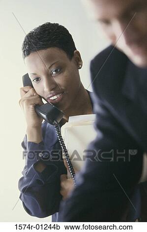 Businesswoman talking on a landline telephone View Large Photo Image Stock Image - Businesswoman talking on a landline telephone. Fotosearch