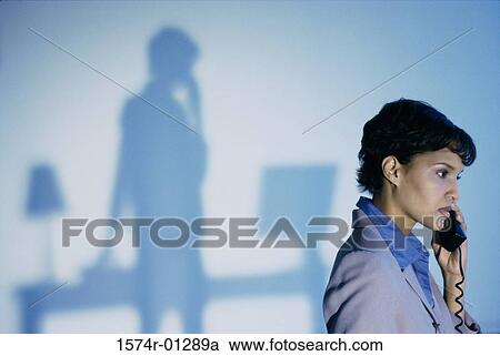 Businesswoman talking on a landline telephone View Large Photo Image Stock Image - Businesswoman talking on a landline telephone. Fotosearch