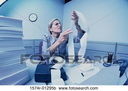 Stock Image - Businesswoman working in an office. Fotosearch