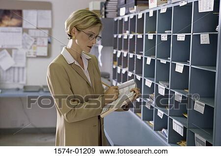 Stock Photo - Businesswoman writing in a book. Fotosearch