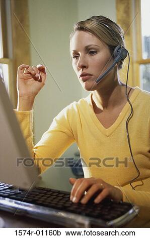 Stock Image - Businesswomen wearing a headset. Fotosearch