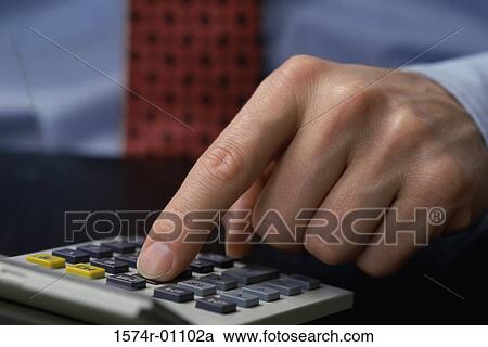 Close-up of a businessman's finger operating a calculator View Large Photo Image Stock Image - Close-up of a businessman's finger operating a calculator. Fotosearch