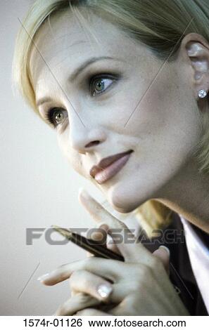 Stock Photograph - Close-up of a businesswoman holding a pen. Fotosearch