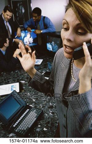 Close-up of a businesswoman talking on a mobile phone in a meeting View Large Photo Image Stock Image - Close-up of a businesswoman talking on a mobile phone in a meeting. Fotosearch