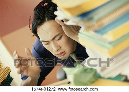 Close-up of a young businessmen holding his head in frustration View Large Photo Image Stock Image - Close-up of a young businessmen holding his head in frustration. Fotosearch